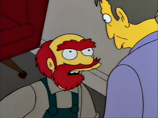 A bald, red-bearded man in green overalls and a white shirt, unnamed since he matches no regular, shouts angrily at a man…