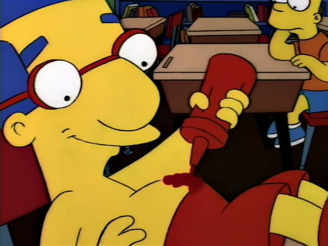 Milhouse sits slumped back in a classroom chair with his feet up on a desk, squeezing a red ketchup bottle onto his red…