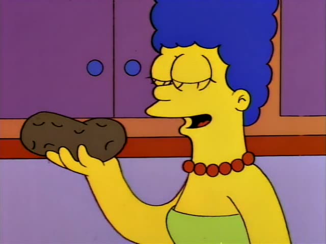 Marge holds up a brown potato-shaped rock in the first frame, then Bart in an orange shirt and Lisa in a red dress…