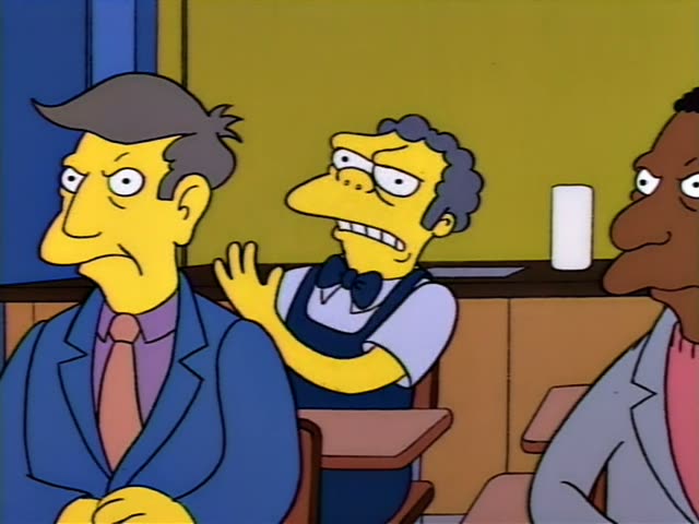 Principal Skinner, Moe, and Carl sit at small classroom desks in front of a chalkboard…