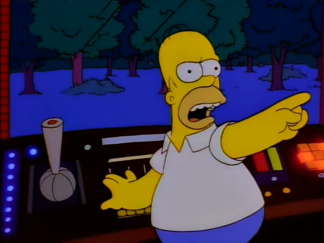 Homer Simpson stands at a control panel inside a spacecraft with a dark blue star-filled view of trees and ground, first…