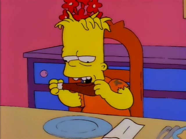 Bart chews on a brown piece of food with his eyes shut at the dinner table, then sits with a napkin tucked into his collar…