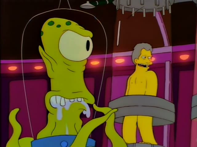 Two green, one-eyed tentacled aliens with toothy grins and drool stand in a purple control room, and a nude, stooped…