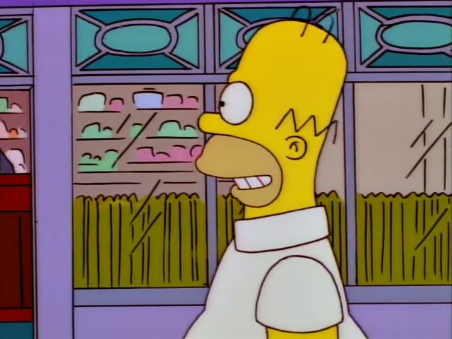 Homer Simpson, Marge Simpson, Lisa Simpson, Bart Simpson and baby Maggie Simpson in her stroller stroll along a shopping…
