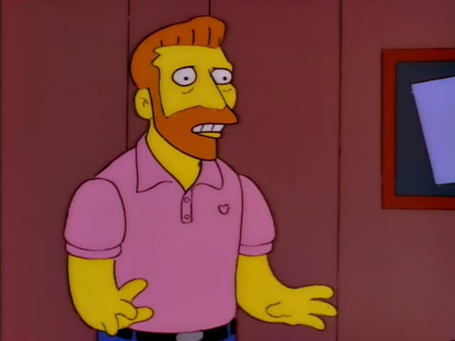 Homer stands with his arm around the shoulder of a ginger-bearded man in a pink polo shirt with a heart on the pocket…