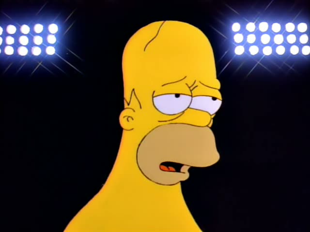 Homer Simpson appears first in close-up under bright stadium lights against a black background, looking sullen and squinting