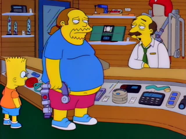 Bart stands at a glass display counter in a cluttered electronics shop with a green carpet, facing a heavy, stubbled man…