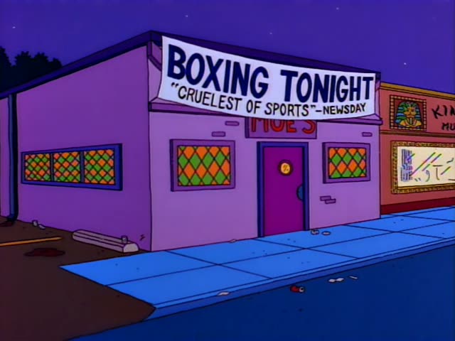 Barney leans on the bar at Moe's, ringside behind the boxing ropes, talking and then clenching his fist with a sly grin…