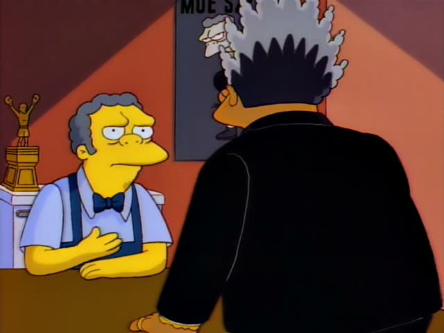Moe leans on the counter of his tavern with a trophy and boxing-glove pictures on the wall behind him