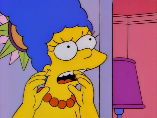 Marge Simpson stands beside a purple lampshade in a pink room and peers around a doorframe