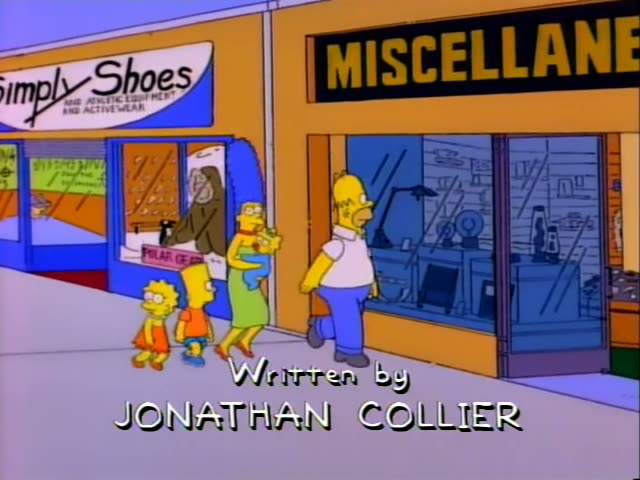 Homer, Marge holding baby Maggie, Bart and Lisa stand together on a mall walkway in front of a Phineas Q. Buzzbaum's 5600…