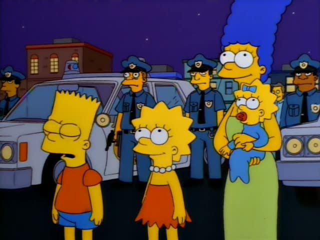 Bart, Lisa, Marge, and baby Maggie stand at night in front of a row of police officers and a parked police car, with Bart…