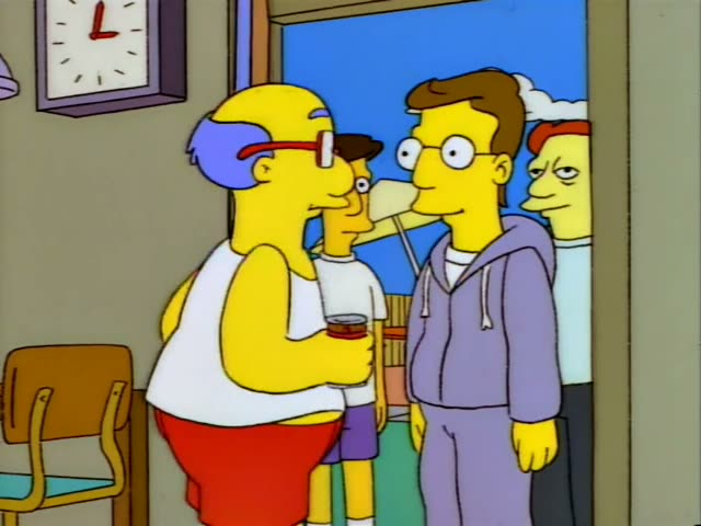 A heavy, bald-topped man with blue hair, red glasses and a white tank top with red shorts stands in an open doorway…