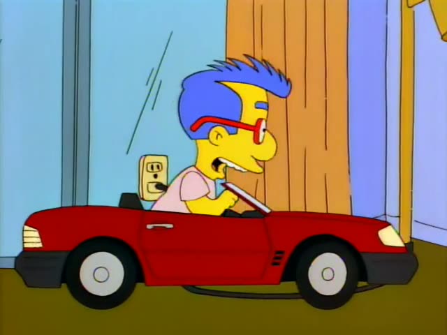 Milhouse sits at the wheel of a red convertible indoors, first gripping the steering wheel in a pink shirt and then leaning…