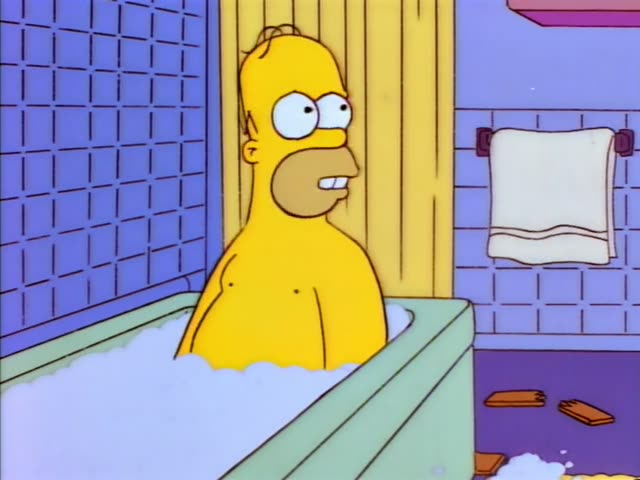 Homer sits naked in a green bathtub full of white suds in a blue-tiled bathroom, with a yellow shower curtain behind him