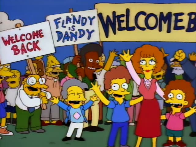 Ned Flanders stands between Homer in his white shirt and a bald man in glasses and a white lab coat, first in front…