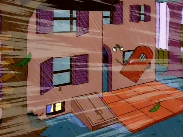 Marge stands beside Maggie on a green couch, while Bart, Lisa and Homer sit on folding chairs and a figure in a red Santa…