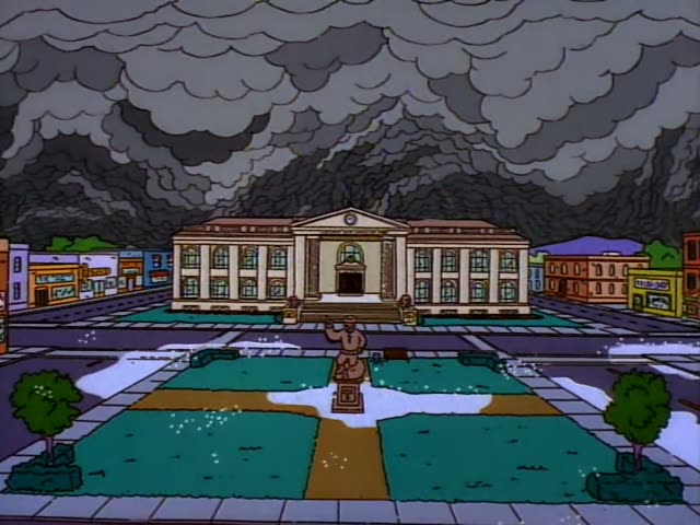 Homer, Marge, Bart, Lisa and Maggie appear in a cluttered basement, after an opening view of a columned building under dark…