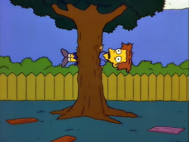 Ned Flanders hugs a curly red-haired boy in a blue shirt against a large tree trunk, then stands at a yellow picket fence…