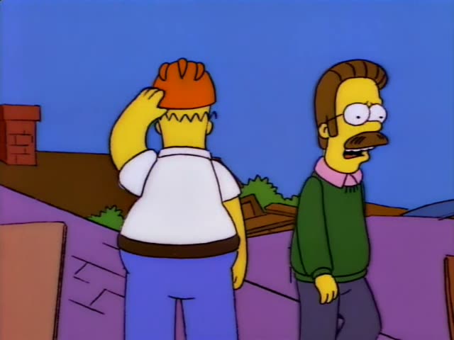 Ned Flanders stands on a rubble-strewn lot beside Homer, seen from behind in a white shirt and blue pants with an orange cap…