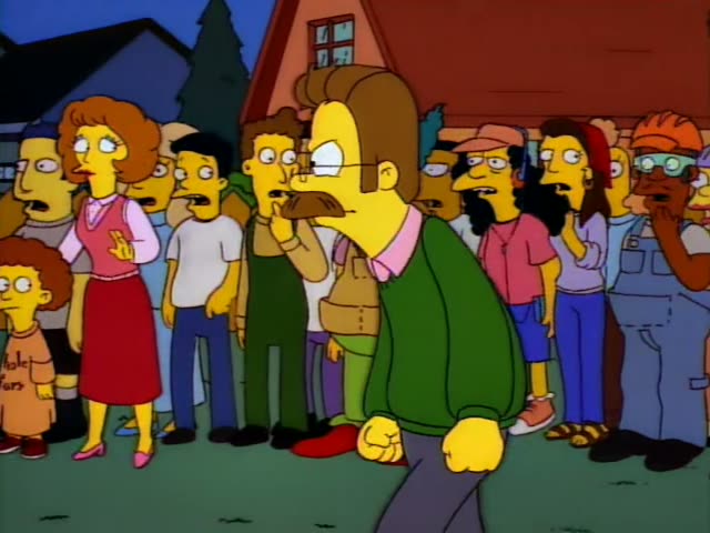 Ned Flanders stands among a crowd of neighbors on a grassy street, with Krusty the clown in the group, while a red-haired…