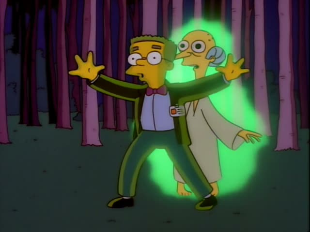 Smithers stands with his arms spread in front of Mr. Burns, a frail, stooped old man with a hooked nose and grey hair…