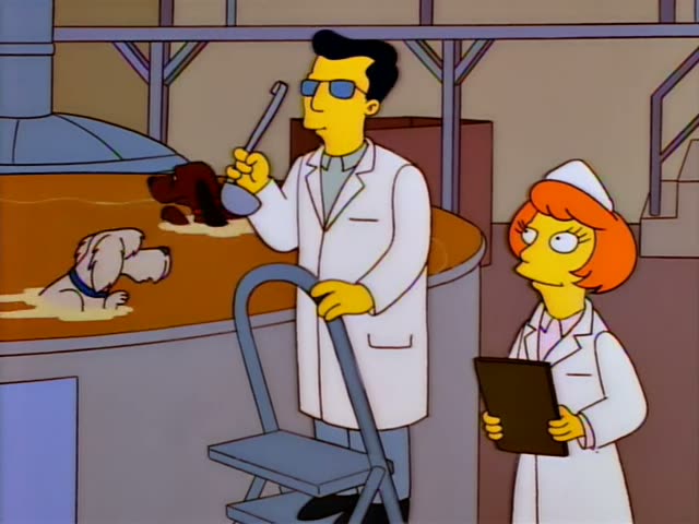 A man in a white lab coat and dark sunglasses with slicked black hair stands beside a woman in a white lab coat and nurse's…