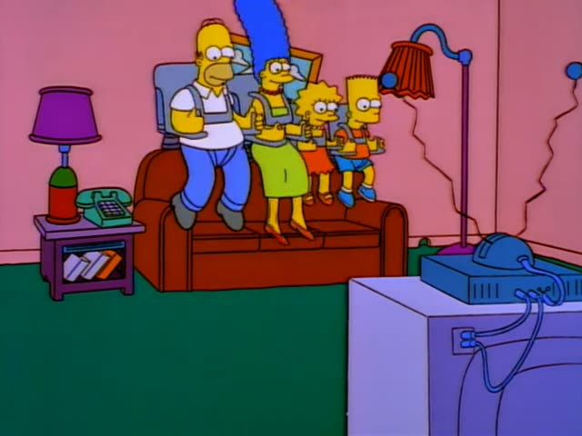 Homer, Marge, Lisa and Bart sit side by side on a brown couch in a pink living room, Homer on the left in a white shirt…