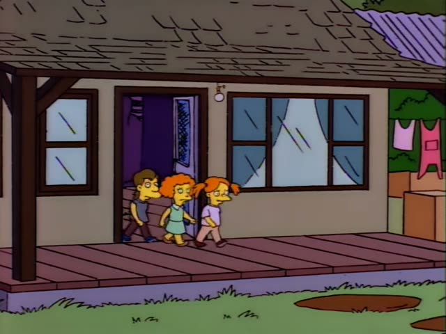 A line of cartoon children and adults gathers on the wooden porch of a small house with a sloped shingled roof and an open…