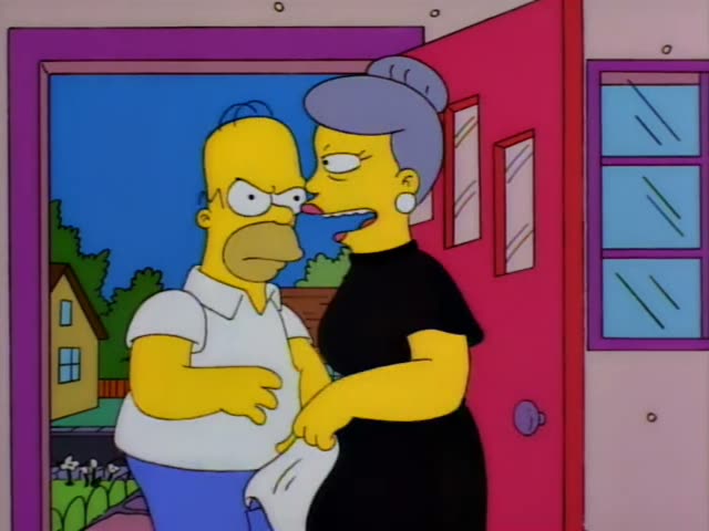 Homer and a woman with a grey-violet bun wearing a black dress stand in the red doorway of a pink house, the woman glancing…