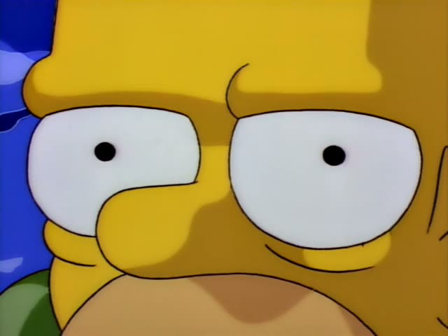 Mr. Burns leans toward Homer, who sits cross-legged on an icy wooden floor wrapped in a green blanket and clutching it…