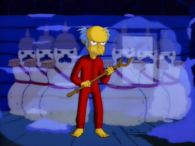 Mr. Burns wears red pajamas and grips a wooden cane-like staff while facing Homer, who stands in white briefs and a green…