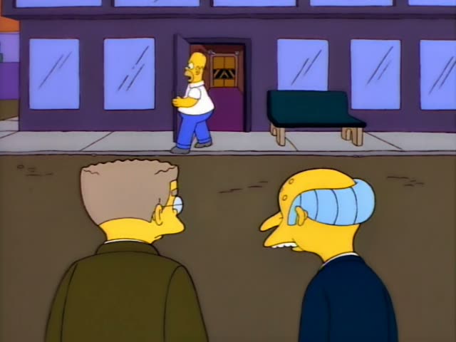 Homer Simpson bursts out of a purple building's doorway and runs along the sidewalk past a green bench, glancing back as he…