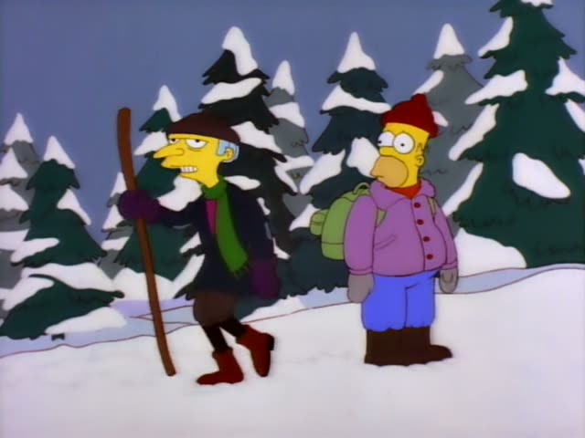Mr. Burns and a heavy man in a red knit hat, purple jacket, blue trousers and green backpack stand on a snowy path among…