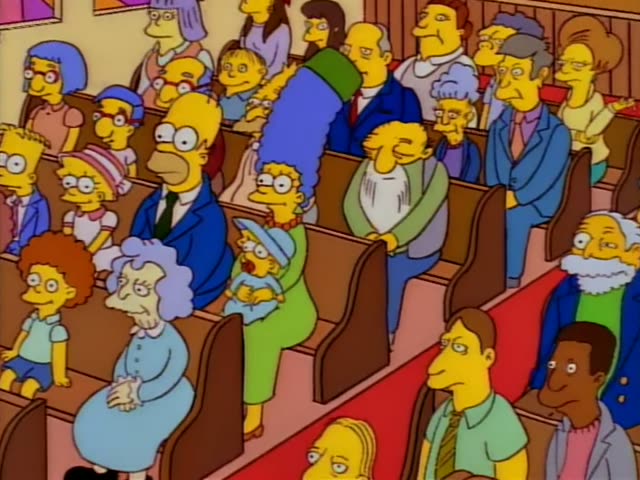Homer, Marge with a tall blue beehive and baby Maggie with her pacifier sit among a crowded church congregation, with an old…