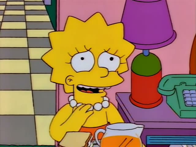Lisa sits at the table eating a sandwich in the first part, then the Simpson family stands in the yellow-and-grey checkered…