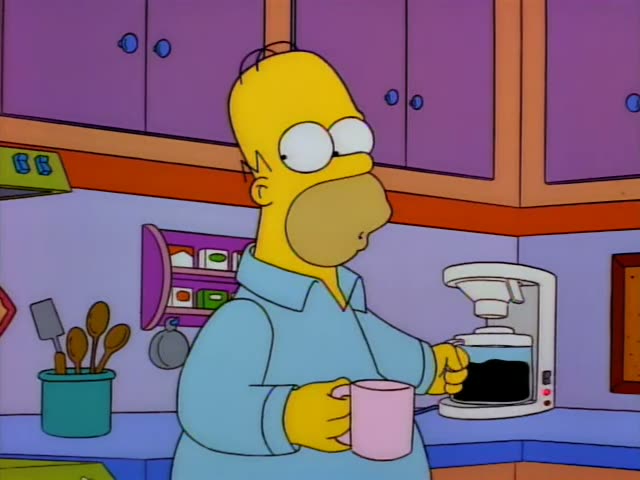 Homer Simpson stands in the kitchen by the coffee maker, gesturing and talking, then pauses with his hand to his chin