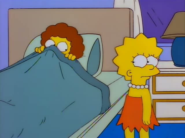 Lisa Simpson in an orange skirt and pearl necklace stands beside a bed where a curly-haired woman in a blue blanket pulls…