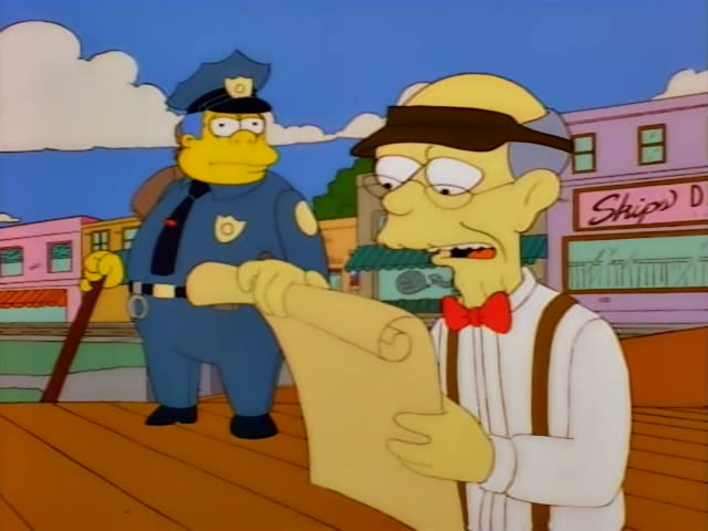 Chief Wiggum stands on a wooden boardwalk in a small town street while an elderly one-off man in a straw hat, red bow tie…