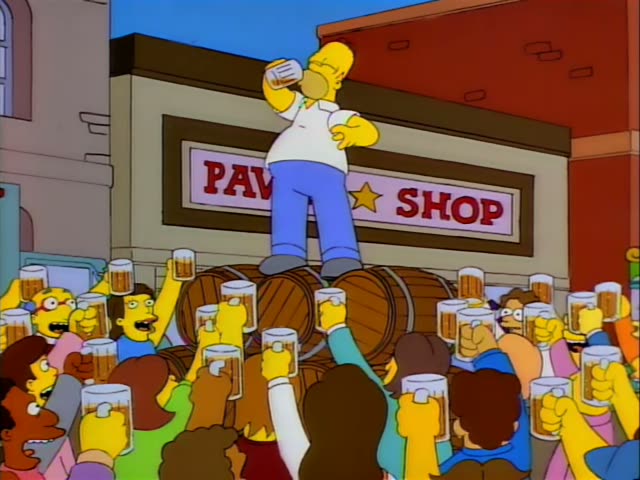 Homer stands atop a row of wooden barrels in front of a PAWN SHOP sign, drinking from a mug while his other hand rests…