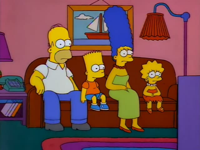 Homer, Marge, Bart and Lisa sit side by side on the brown living room couch in front of a sailboat painting and a red…