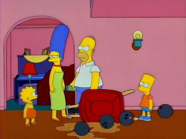 Homer, Marge, Lisa and Bart stand in a pink living room beside a tipped red wheelbarrow with bowling balls and a brown…