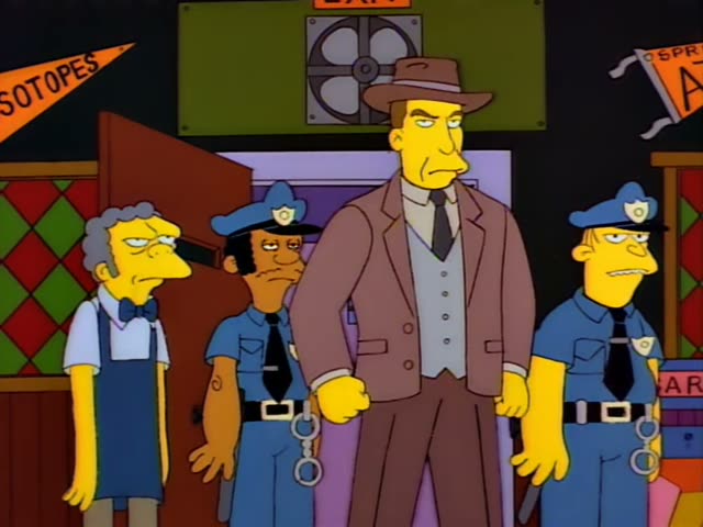 Moe stands by a doorway marked EXIT while two uniformed police officers and a man in a brown fedora and suit stand beside him
