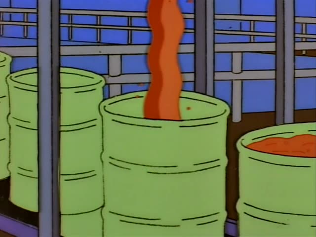 Mr. Burns stands beside Lisa, who wears a red dress and a pearl necklace, in a factory room