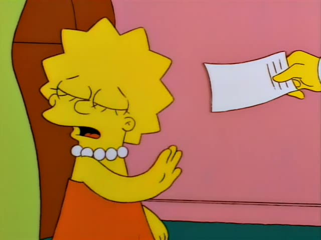 Lisa Simpson stands beside a brown chair against a pink wall in a room