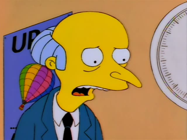 Mr. Burns and his thin assistant Smithers stand in an office corridor beside a door with a red alarm bell above it