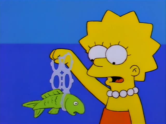 Lisa Simpson and the frail, stooped Mr. Burns stand on a sandy beach beside blue water