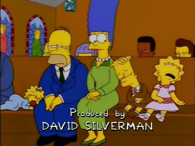 Homer, Marge, Bart and Lisa sit in a church pew with Maggie, pacifier in mouth, on Homer's lap, while the on-screen credit…