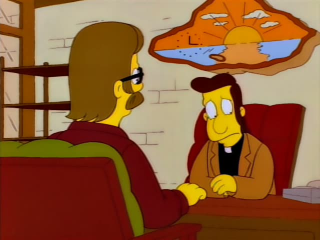 A long-haired bearded man in dark red clothes and glasses sits with his back to the viewer, facing a nervous man…