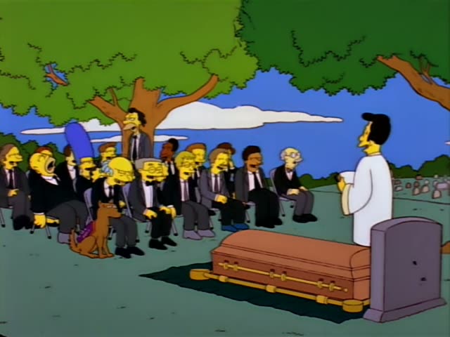 Marge Simpson with her tall blue beehive sits with a row of mourners in black suits and Santa's Little Helper, the brown…